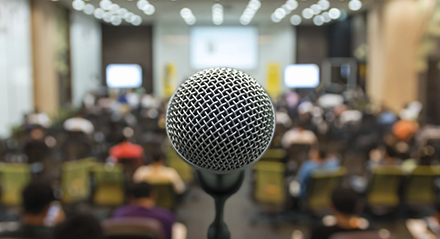 close up of microphone in front of crowd