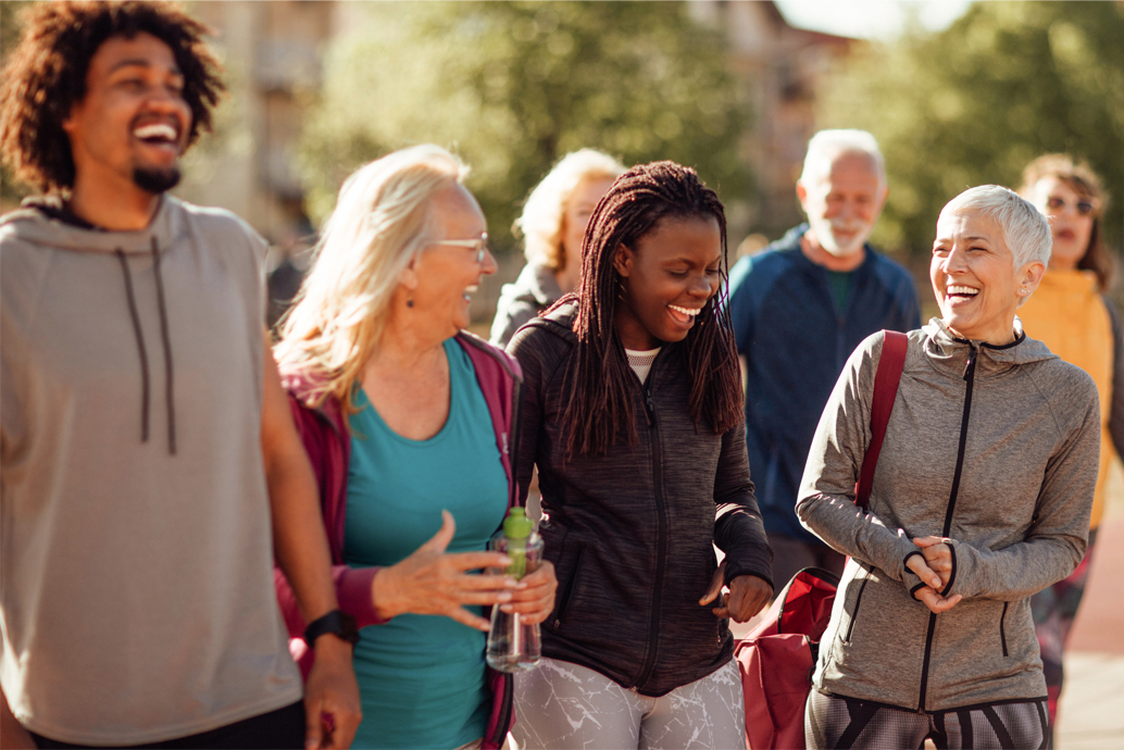  Diverse group of people gathered laughing together at a community event
