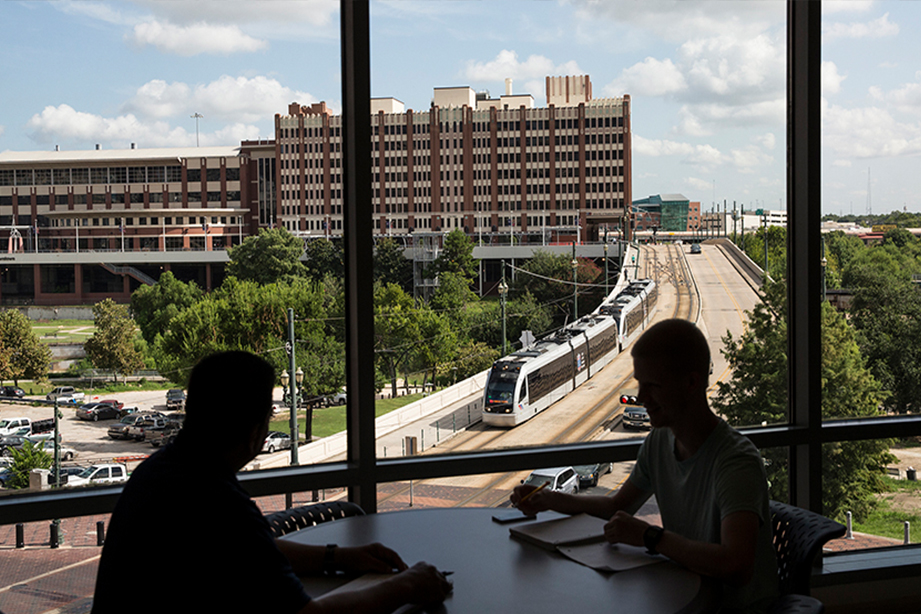 Students at the 2nd floor window at the Commerce St. Building