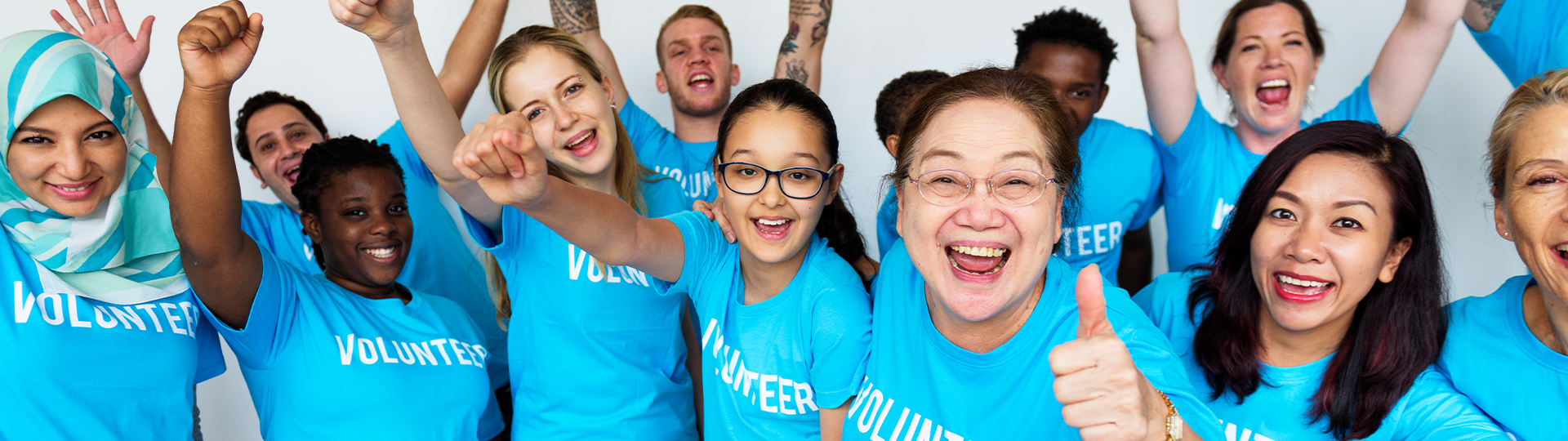 Group od Blue Shirt Volunteers Smiling