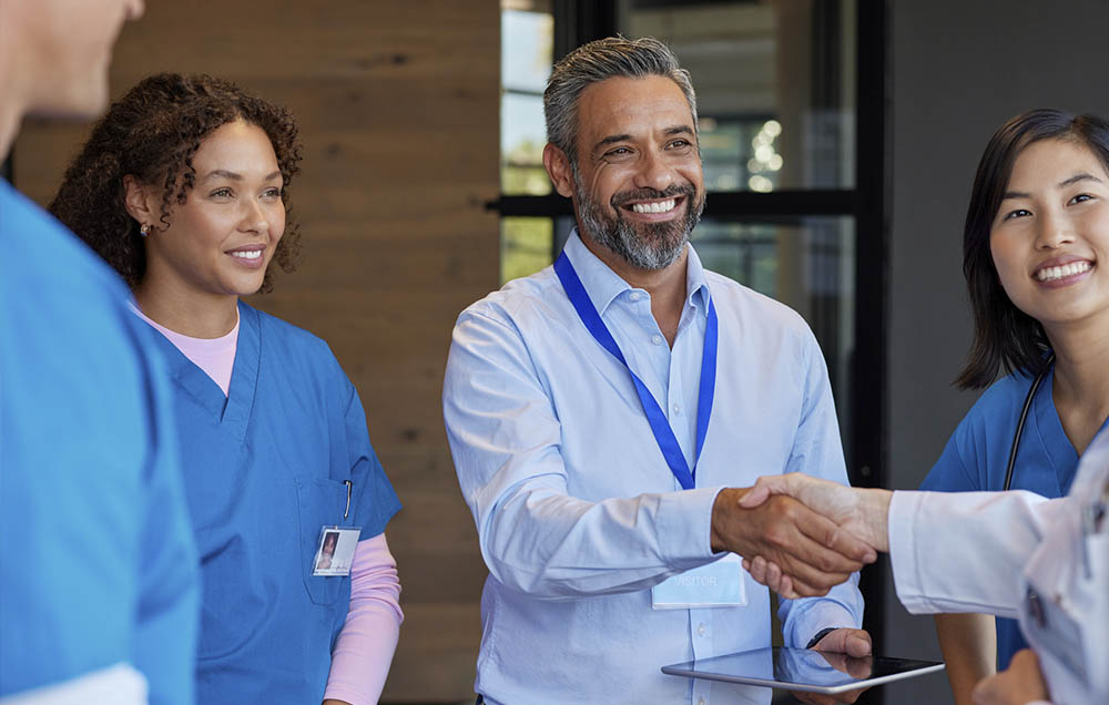 Social Worker in a hospital meeting shaking hands