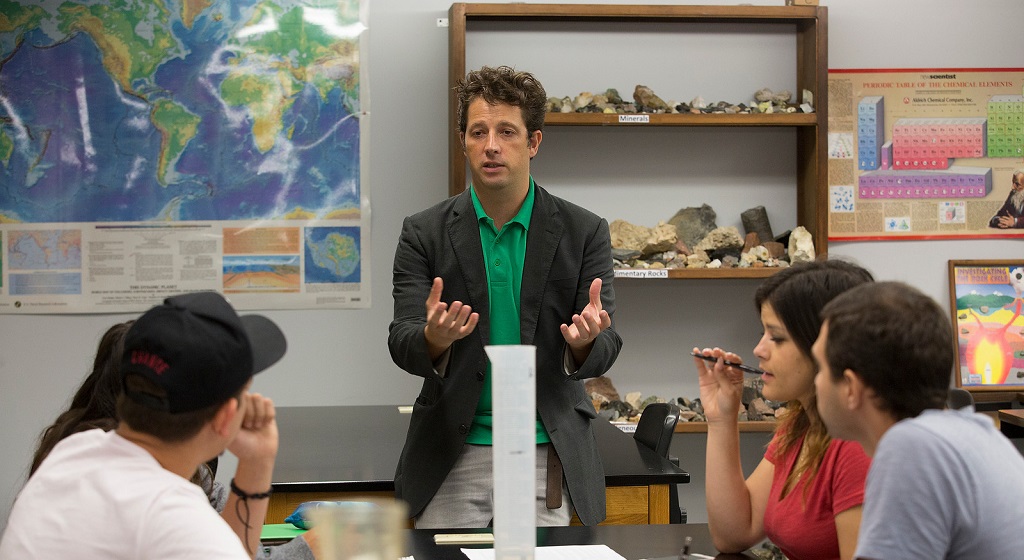 Professor talking to a group of students.