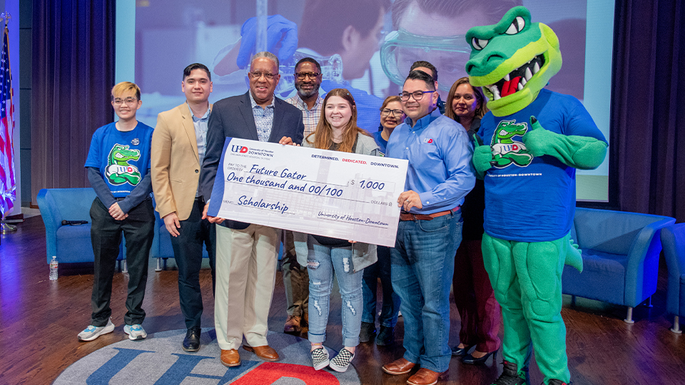 Group photo with a student receiving a scholarship