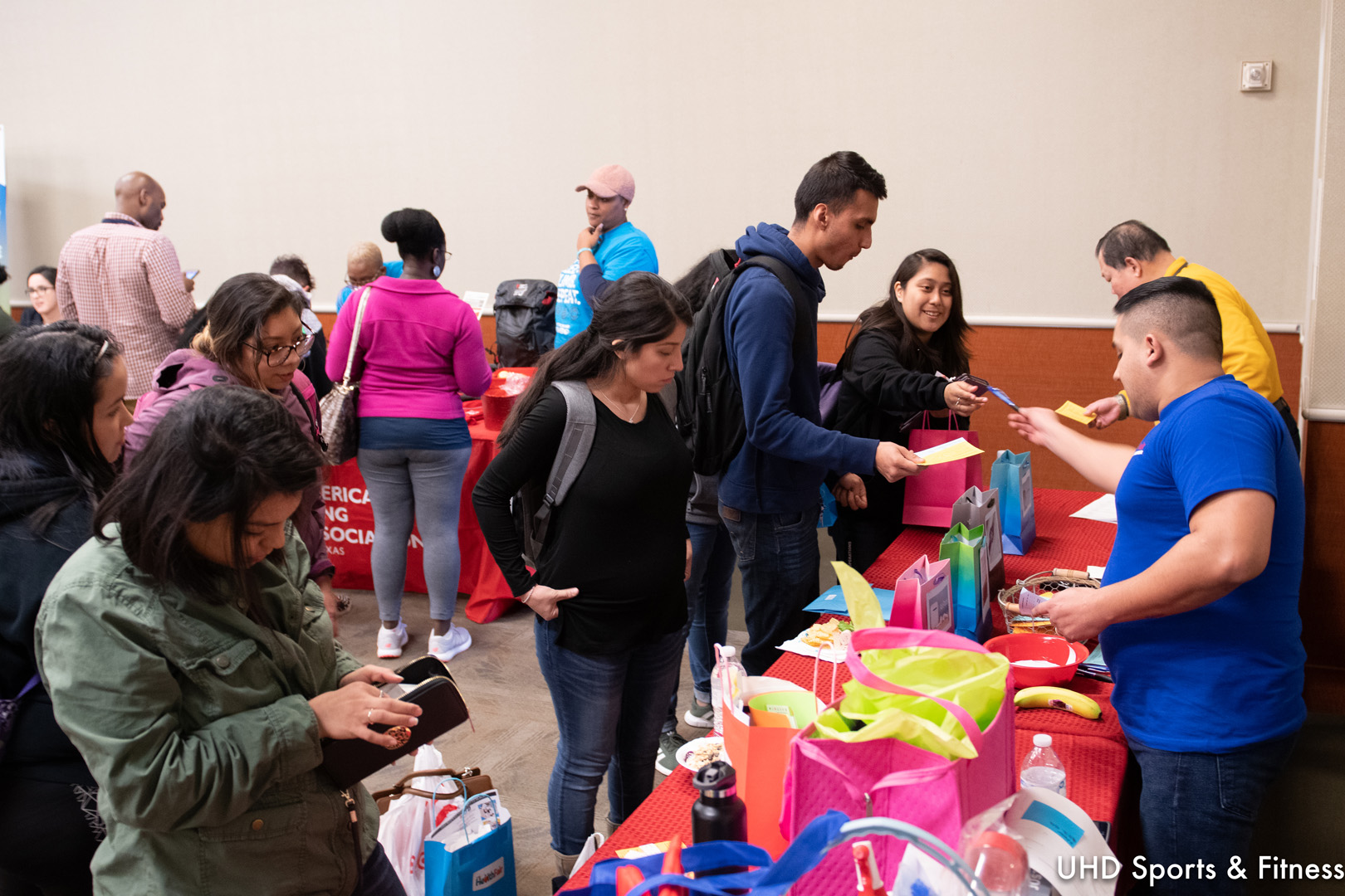 Students interacting with table booths at an event on campus in A300.