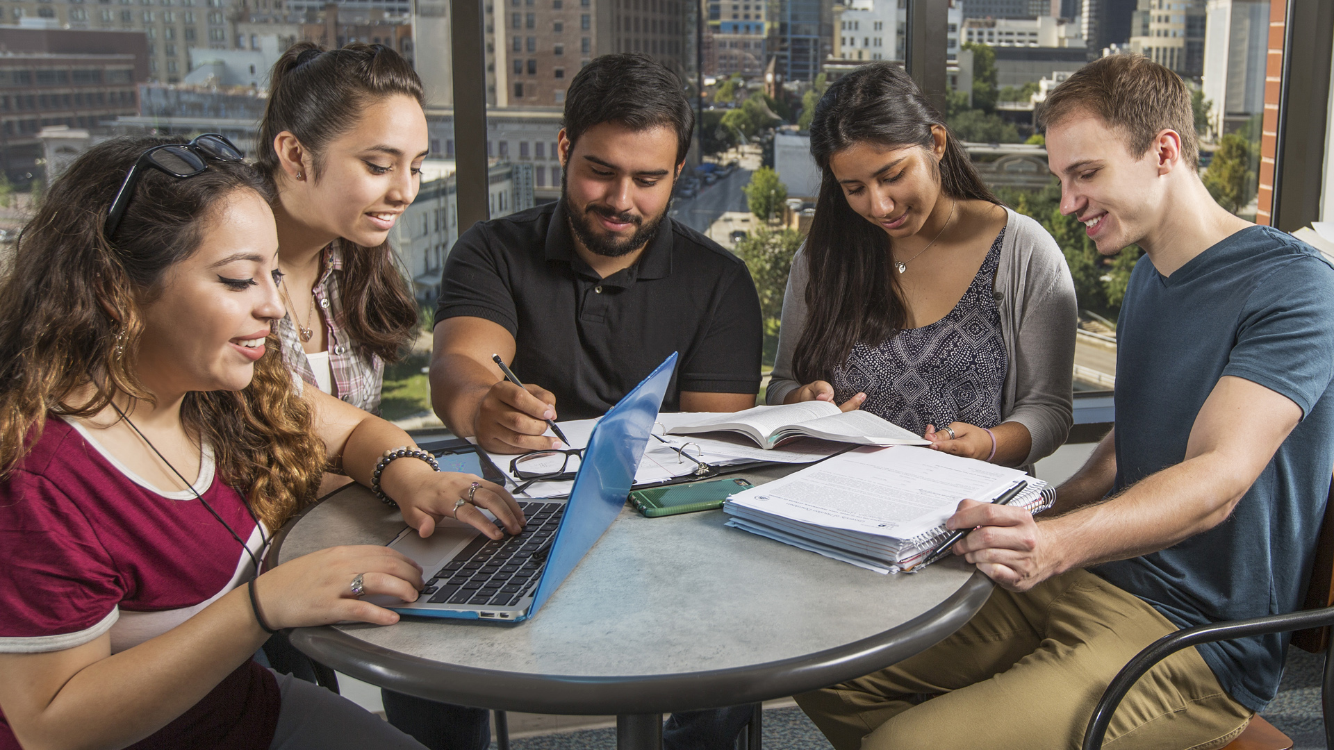 UHD students sitting at a round table working together