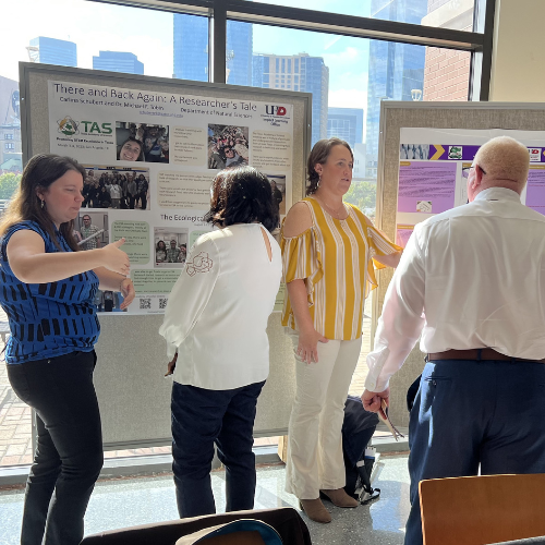 Students and faculty members at presentation boards in one main building at the university of houston downtown