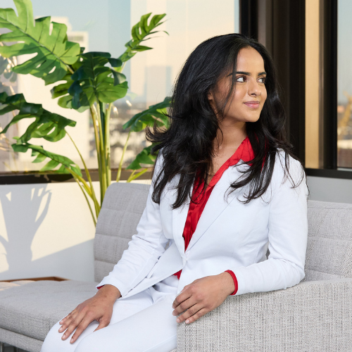 University student Shivangi Pathak smiles while wearing a pant suit at University of Houston Downtown's Law Summit at UHD@1801 Main in downtown houston