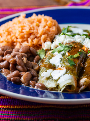 enchiladas, pinto beans, and rice