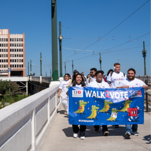 Students hold a walk2vote banner at the university of houston downtown